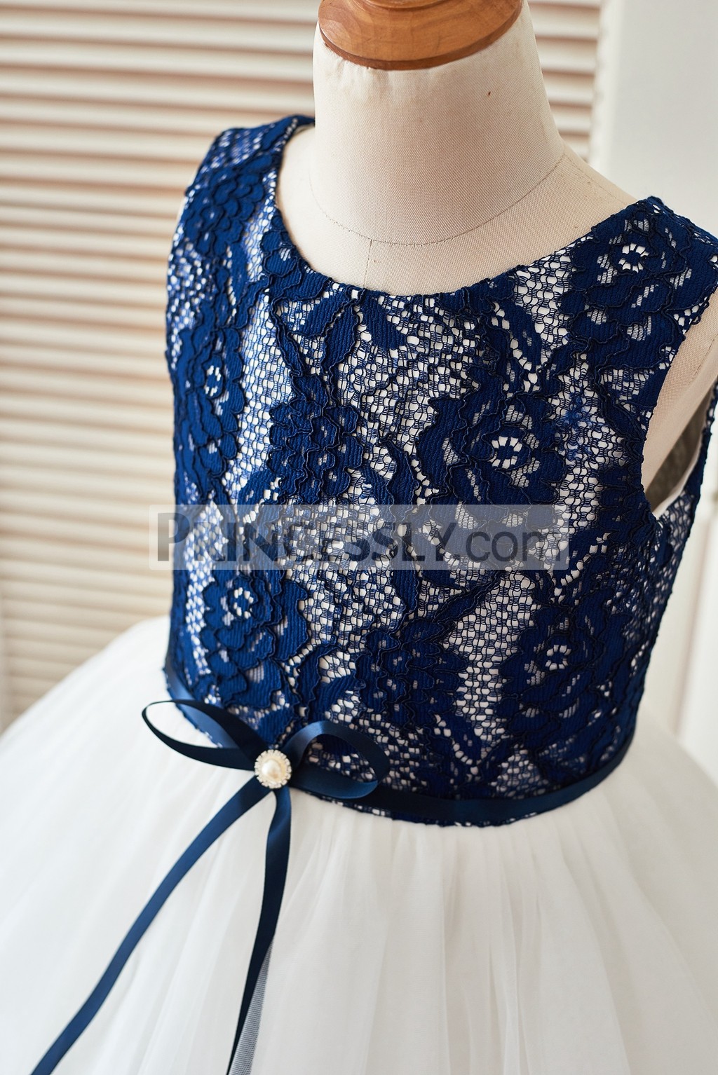 Navy blue lace bodice in scoop neckline and sleeveless with a brooch ribbon