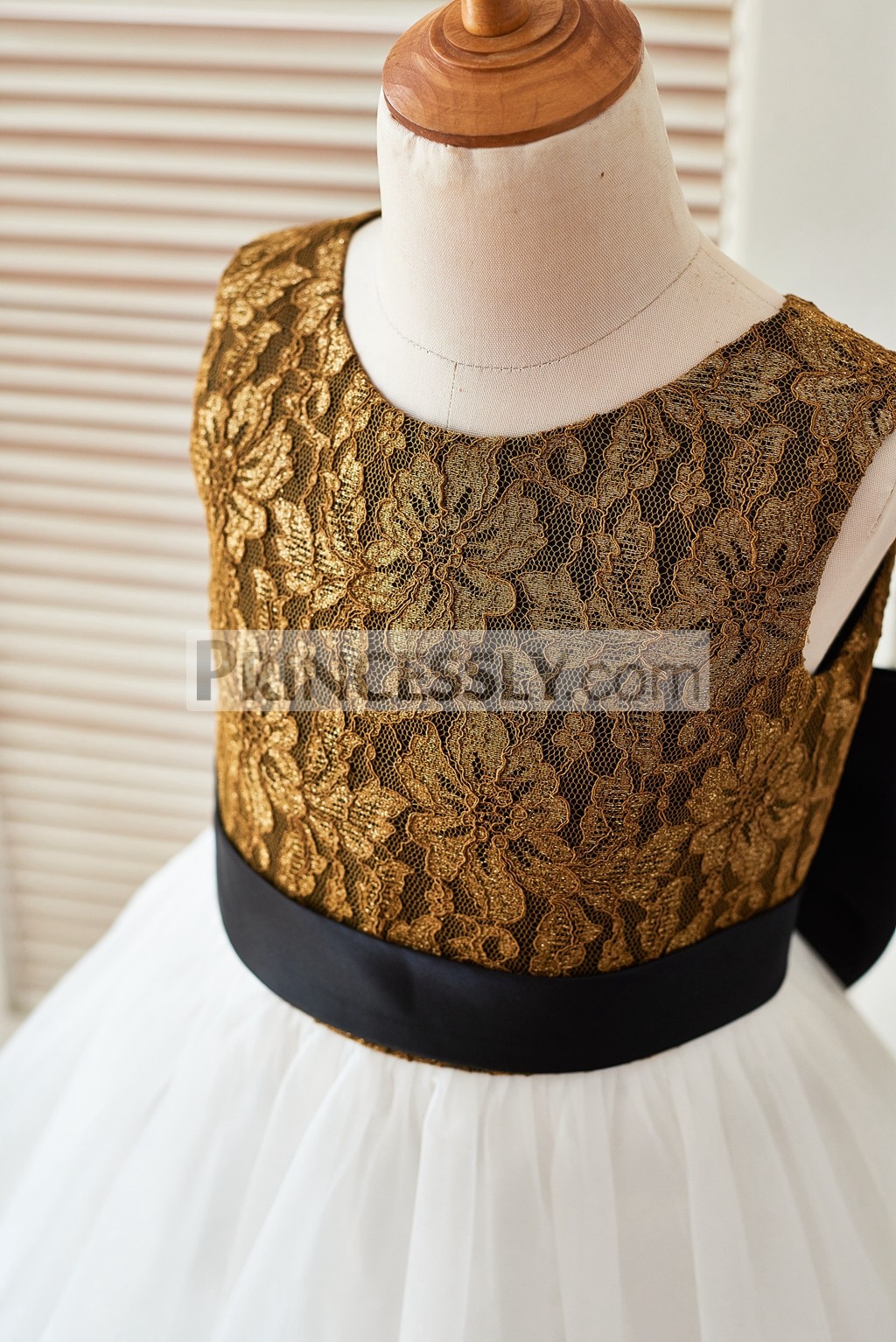 Gold lace bodice in scoop neckline and sleeveless with a black satin belt